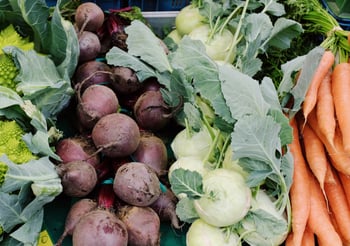 Beets, lettuce, and carrots in a grocery store.