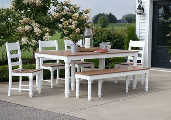 White outdoor dining table set with four chairs and a bench.