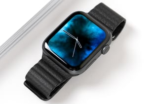 Black smartwatch folded up lying on a table.