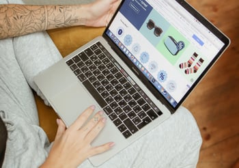 Person online shopping on a laptop.