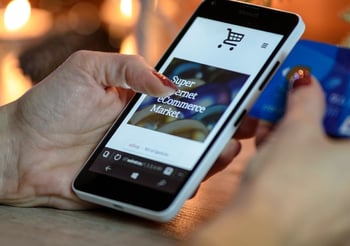 Person online shopping on their mobile phone.