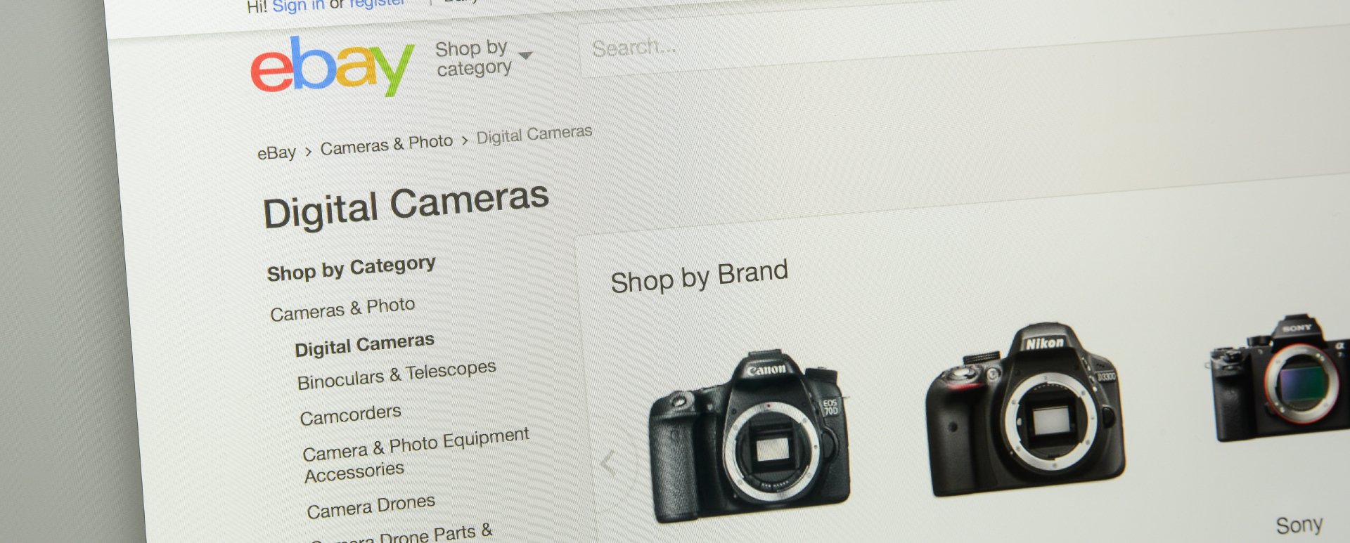 eBay online store displaying digital cameras pulled up on a desktop computer.