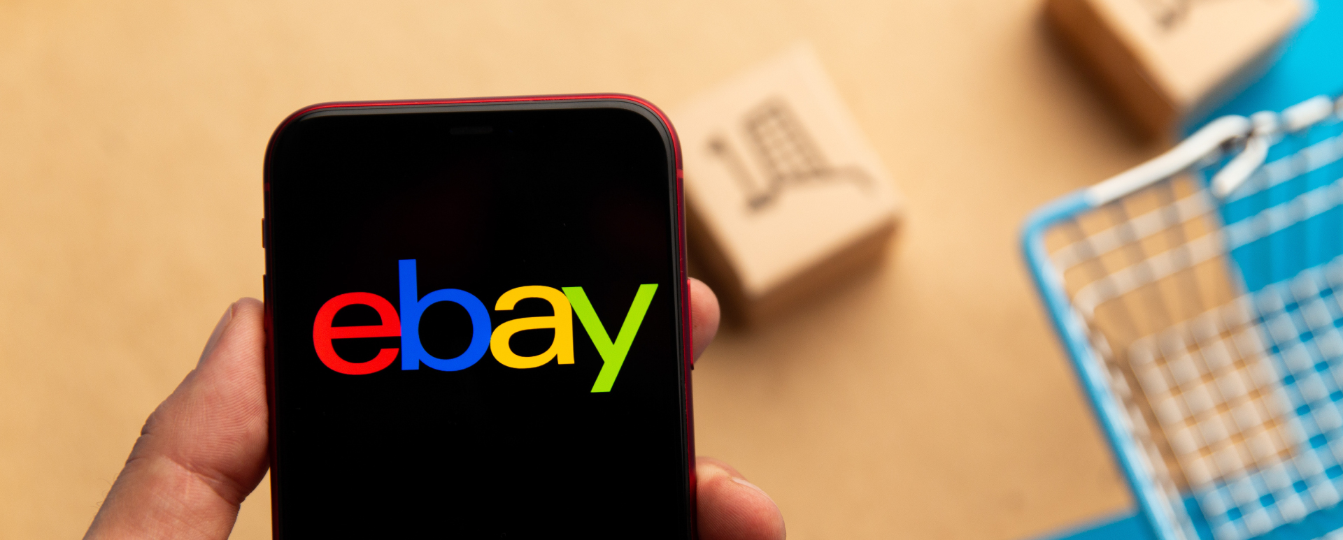 A person opening up the eBay app on a mobile phone.