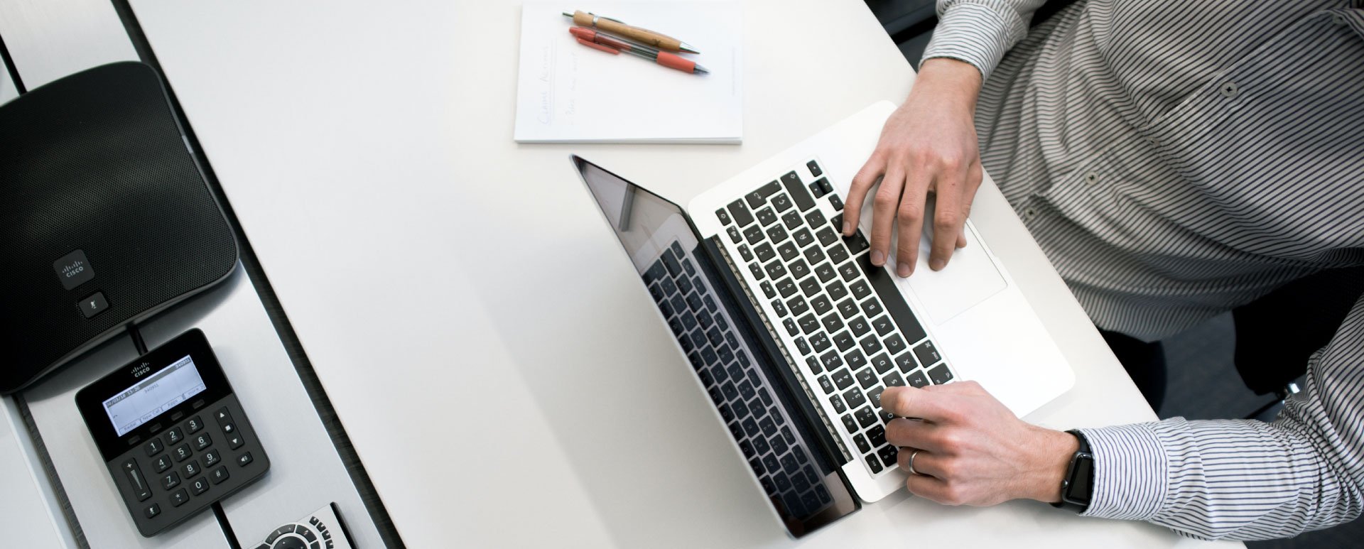Overhead view of a person working on a laptop.